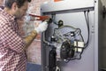 Plumber repairing a condensing boiler in the boiler room Royalty Free Stock Photo