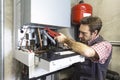 Plumber repairing a condensing boiler Royalty Free Stock Photo