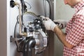 Plumber repairing a condensing boiler Royalty Free Stock Photo