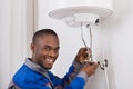 Plumber Repairing Electric Boiler Royalty Free Stock Photo