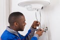 Plumber Repairing Electric Boiler Royalty Free Stock Photo