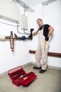 Plumber repairing metallic water pipes with wrench