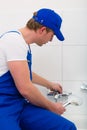 Plumber repairing shower in bath room