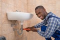 Plumber Repairing Sink In Bathroom Royalty Free Stock Photo