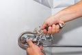 Plumber repairs a shower faucet in the bathroom.