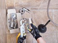 Plumber repairs sink trap in bathroom Royalty Free Stock Photo