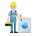 Plumber repairs washing machine. Breakdown of household appliances. Worker with a wrench, tool
