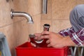 Plumber`s Hand Fixing Sink In Bathroom Royalty Free Stock Photo