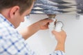 Plumber's hands and washbasin drain at bathroom Royalty Free Stock Photo