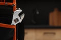 Plumber`s tool bag with adjustable wrench indoors, closeup. Space for text Royalty Free Stock Photo