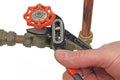 Plumber`s wrench tightening up a valve Royalty Free Stock Photo