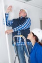 Plumber showing female trainee where to work
