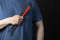 A plumber with a tool for installing and repairing plumbing on a black background