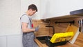 Plumber with toolbox comes to check and fix broken faucet