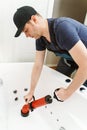 Plumber unclogging bathtub