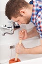 Plumber unclogging a bathtube drain Royalty Free Stock Photo