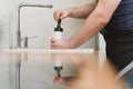 Plumber unclogging kitchen sink Royalty Free Stock Photo