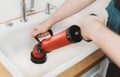 Plumber unclogging kitchen sink Royalty Free Stock Photo