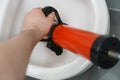 Plumber unclogging toilet Royalty Free Stock Photo