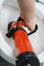 Plumber unclogging toilet Royalty Free Stock Photo