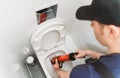 Plumber unclogging toilet Royalty Free Stock Photo