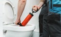 Plumber unclogging toilet Royalty Free Stock Photo