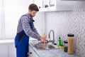 Plumber Using Plunger In Sink Royalty Free Stock Photo