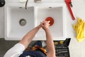 Plumber using plunger to unclog sink drain Royalty Free Stock Photo