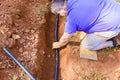 Plumber using thermal insulation PE foam for covering PVC water pipe for underground Royalty Free Stock Photo