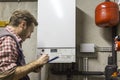 Plumber who carries out the maintenance of a condensing boiler Royalty Free Stock Photo