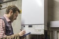 Plumber who carries out the maintenance of a condensing boiler Royalty Free Stock Photo