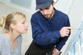 plumber and woman talking at home Royalty Free Stock Photo