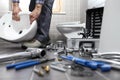 Plumber at work in a bathroom, plumbing repair service, assemble