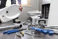 Plumber at work in a bathroom, plumbing repair service, assemble Royalty Free Stock Photo