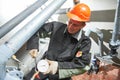 Plumber technician works with water pressure meter in boiler room Royalty Free Stock Photo