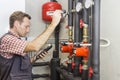 Plumber at work measures the temperature in a boiler room Royalty Free Stock Photo