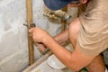 Plumber Working with Pliers