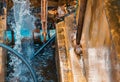 Plumber working repair the broken pipe with Adjustable Wrenches or Locking Pliers in hole ditch at roadside and water Motion Royalty Free Stock Photo