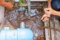 Plumber working repair the broken pipe with Adjustable Wrenches or Locking Pliers in hole ditch at roadside and water Motion Royalty Free Stock Photo