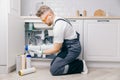 Plumber working replaceable dirty used aqua filter for filtration of reverse osmosis water Royalty Free Stock Photo