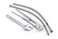 Plumber wrench, adjustable wrench and two hoses with braiding