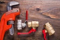 Plumbers fixtures with red handles and monkey Royalty Free Stock Photo