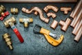 Plumbers tools copper pipes fittings pipe cutter and valwes on black background Royalty Free Stock Photo