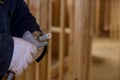 Plumbing building contractor cut a polypropylene pipe with scissors the hands of a worker in white gloves Royalty Free Stock Photo