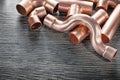 Plumbing copper water pipe fittings on wooden board