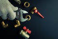 Plumbing equipment on a black background. Valves and wrench