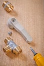 Plumbing fixtures screwdriver on wooden board Royalty Free Stock Photo