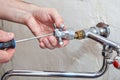 Plumbing repair, plumber unscrews handle kitchen faucet using ha