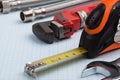Plumbing supplies and tape measure. Royalty Free Stock Photo