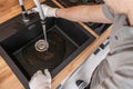 Plumbing Technician Installing Kitchen Sink and a Faucet Royalty Free Stock Photo